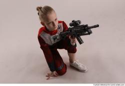 DENISA KNEELING POSE WITH GUN
